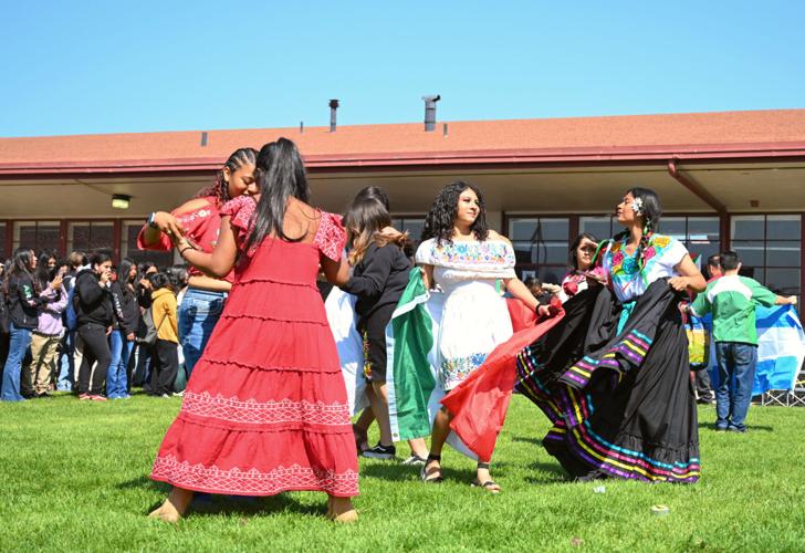 Santa Maria High School students in dresses dance to spanish music at the fall fair lunch time event Friday.