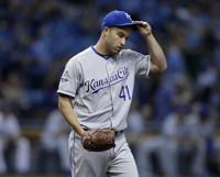 Kansas City Royals pitcher Danny Duffy talks to a fan wearing a