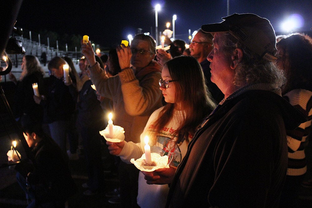 Community mourns fallen officers at candlelight vigil News