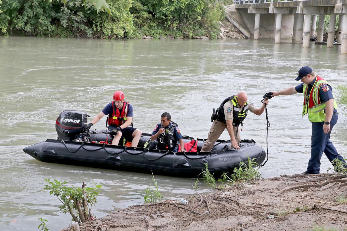 RIVER RESCUE Emergency crews save teen from partially submerged car
