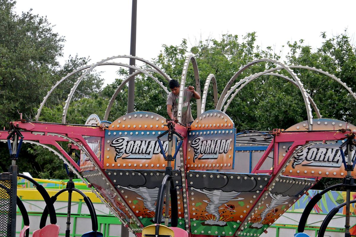 Carnival crews working for the county fair’s opening News