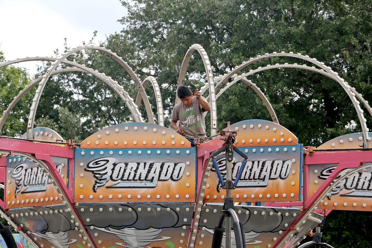 Carnival crews working for the county fair’s opening News