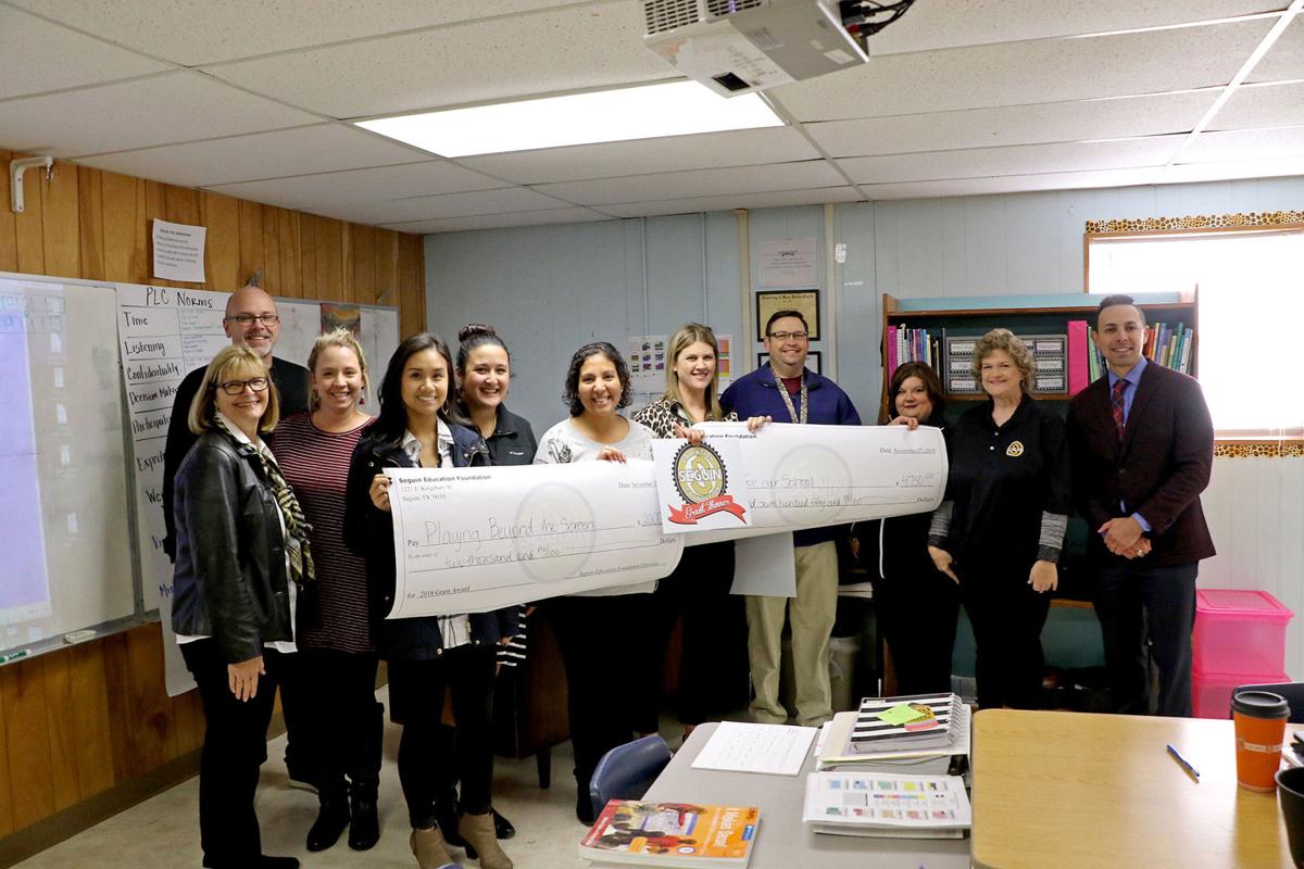 Seguin teachers greeted with giant grant checks News