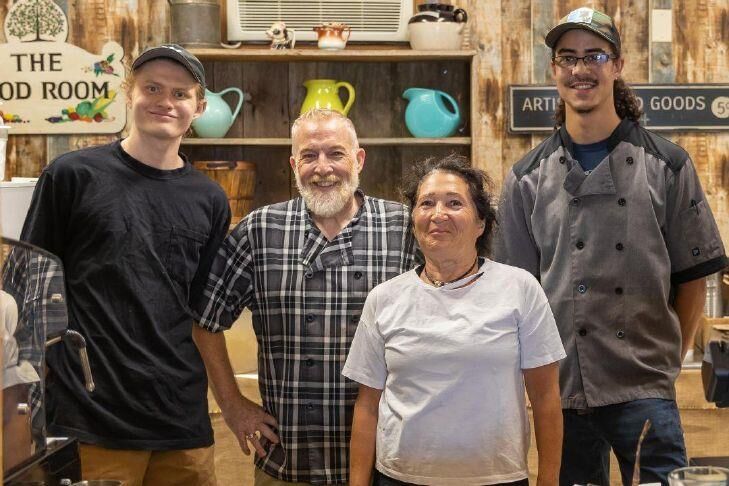 NOTE: Can you please photoshop the yellow pitcher out of the top of the guy's head?CAPTION:Staff pose inside the Optimist Café. From left to right: Keith Asaff, owner KeithWesley, Lisa Amato, and Brandon Ford.
