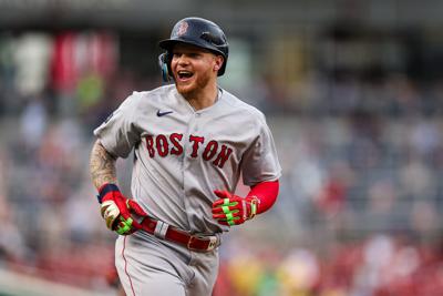 Alex Verdugo reacts with Rafael Devers of the Boston Red Sox after