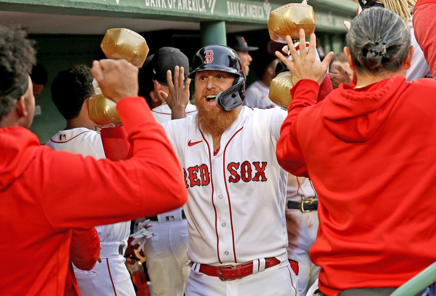 Masataka Yoshida of the Boston Red Sox celebrates in the dugout