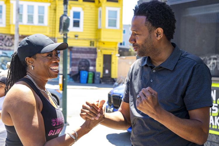 Theo Ellington (right), candidate for District 10 Supervisor, talking with owner Lawanda Dickerson of U3FIT