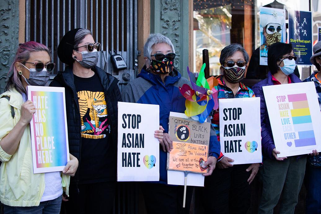 People hold signs at a rally in the Castro held by the LGBTQ+ Asian Pacific Alliance to show support for Asian and Pacific Islanders communities in March 2021. Organizers succeeded in getting larger numbers of Asian voters to oust District Attorney Chesa Boudin and three school trustees from office in more recent elections.