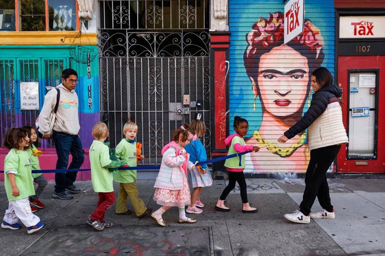Children from Mission Kids Preschool walking to Garfield Square Playground on Monday, Nov. 28, 2022.