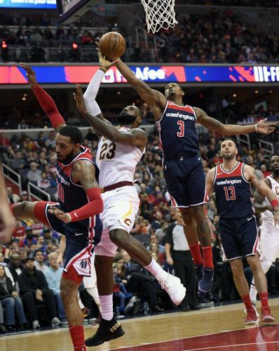 NBA  In special shoes, LeBron's triple-double leads Cavs past Wizards,  106-99