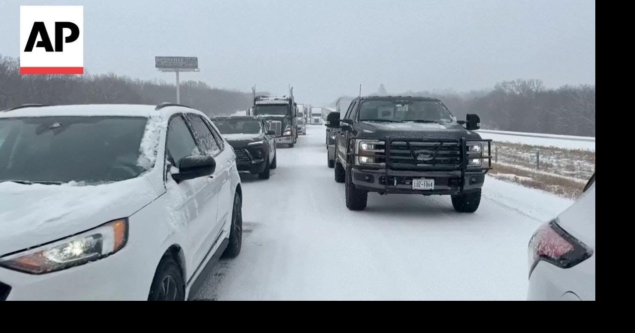 Cars and trucks stuck on snow-covered I-70 in Missouri