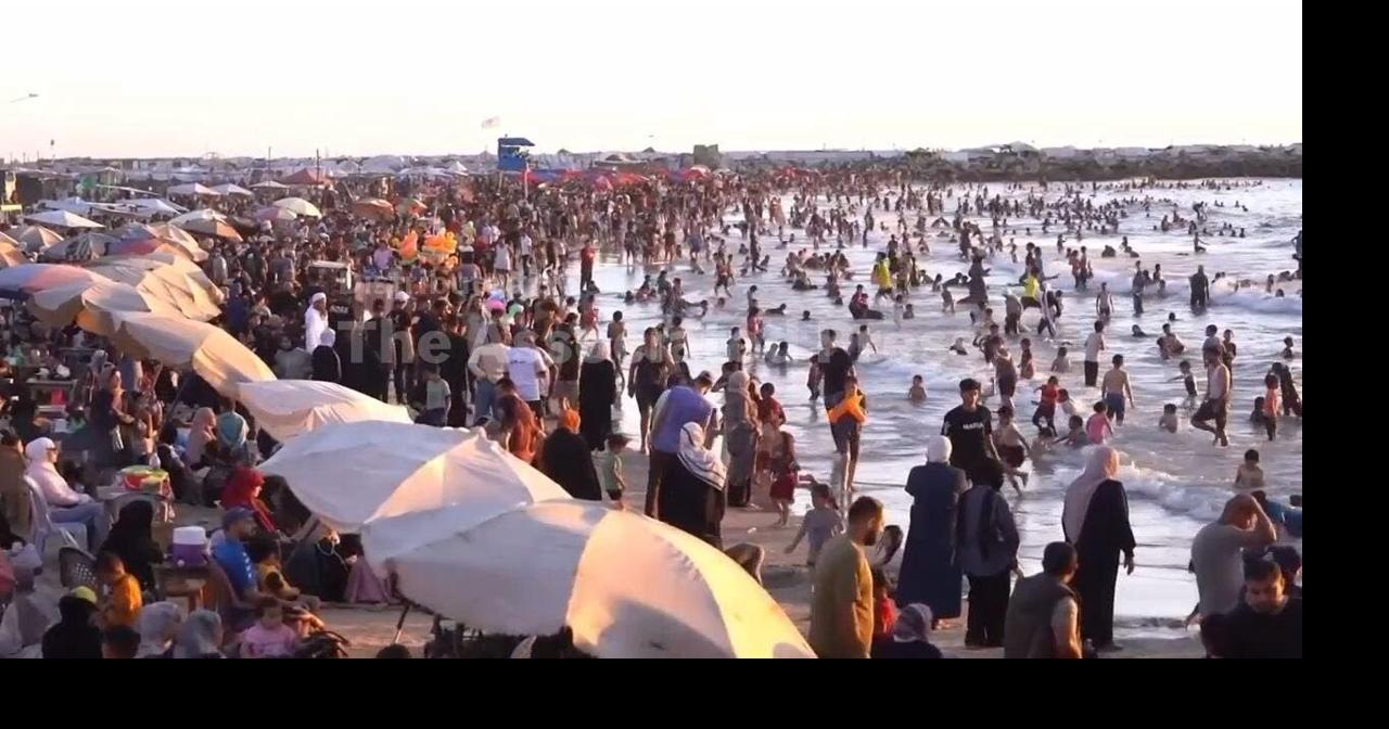 Palestinians in Gaza City flock to beach to escape scorching heat of summer as lengthy war continues