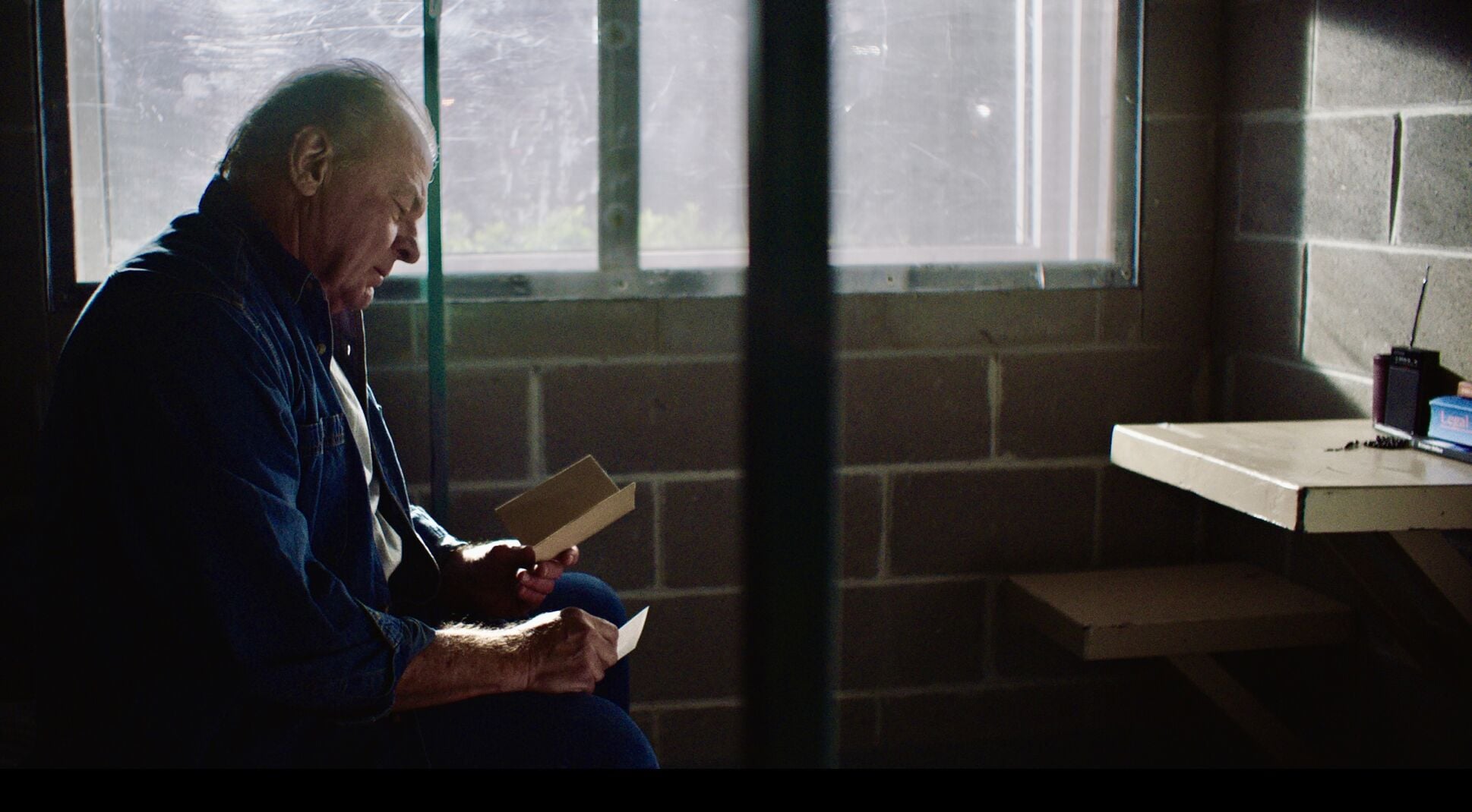 PN 8. 12536 Joel (Michael Bienvenu) in his jail cell looking at a card from Beatrice copy 2.jpg