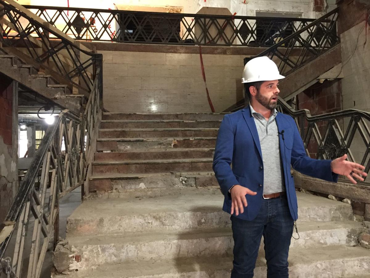 Alex Cherubin stands on the main stairs of the Warrior Hotel