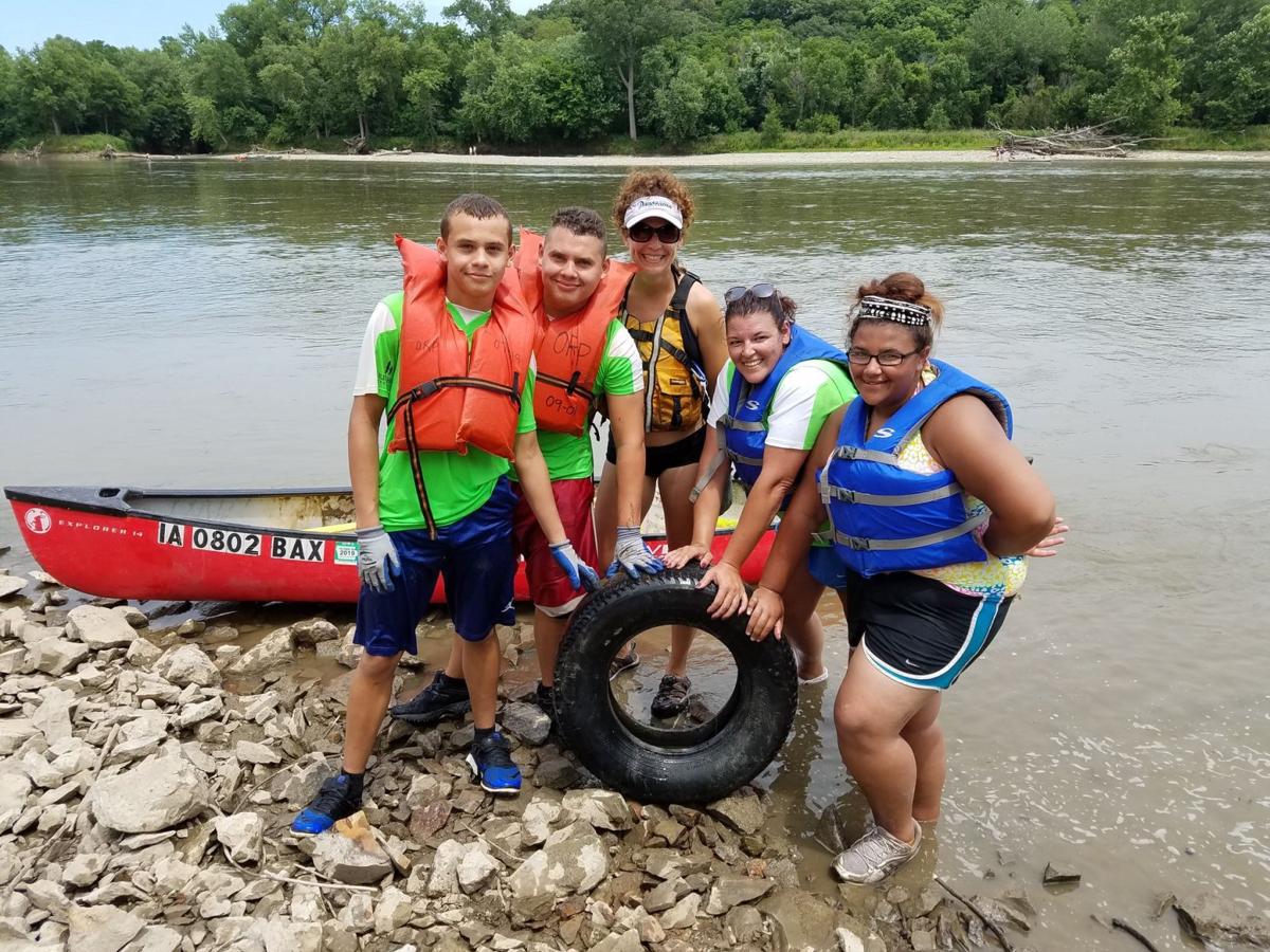 Arthur woman canoes down river, cleans up trash