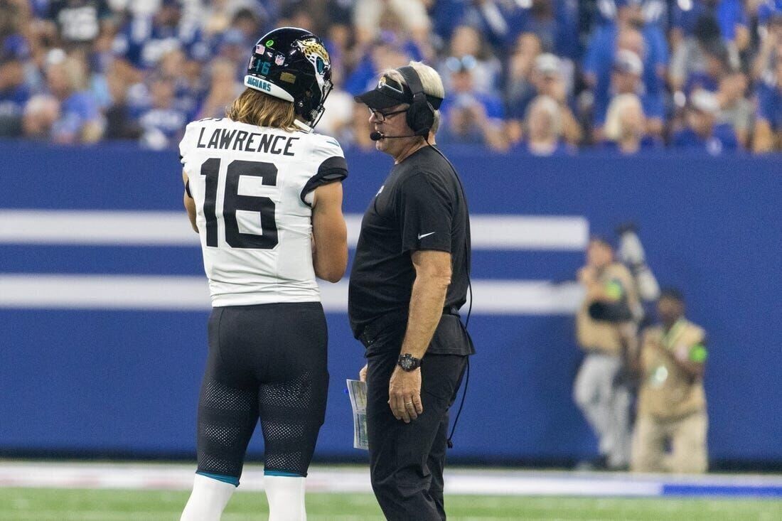 Jacksonville Jaguars quarterback Trevor Lawrence (16) looks for a receiver  against the Denver B …