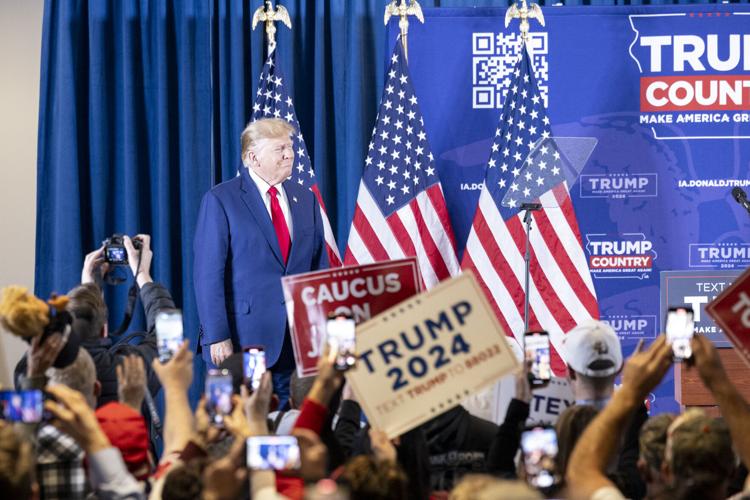 Trump's Iowa campaign rally has stage adorned with mug shot-themed