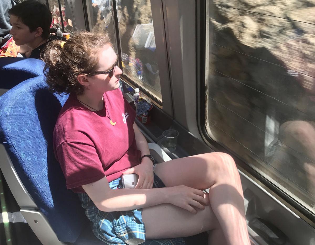 The writer's daughter, Sally Carpenter, soaks up the scenery as Amtrak's California Zephyr climbs into the Rocky Mountains in Colorado.