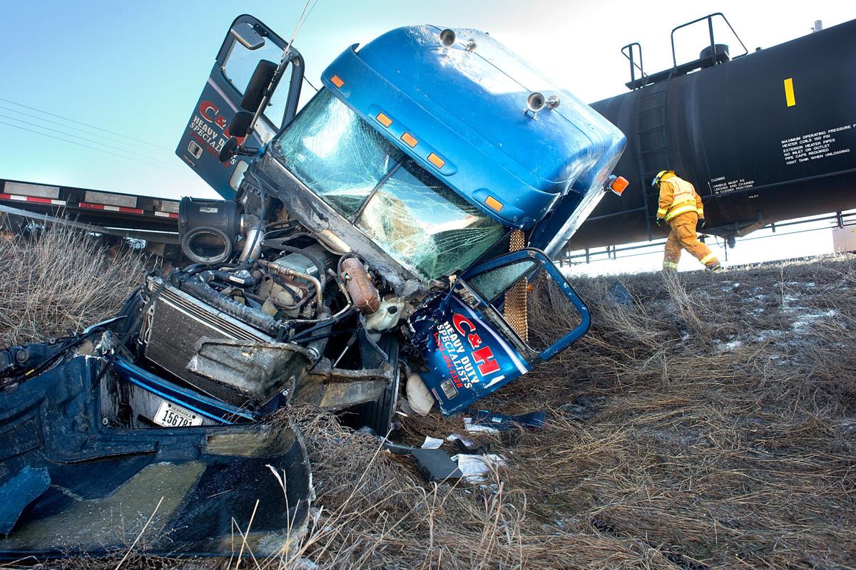 Man taken to hospital with injuries after train, semi collide near