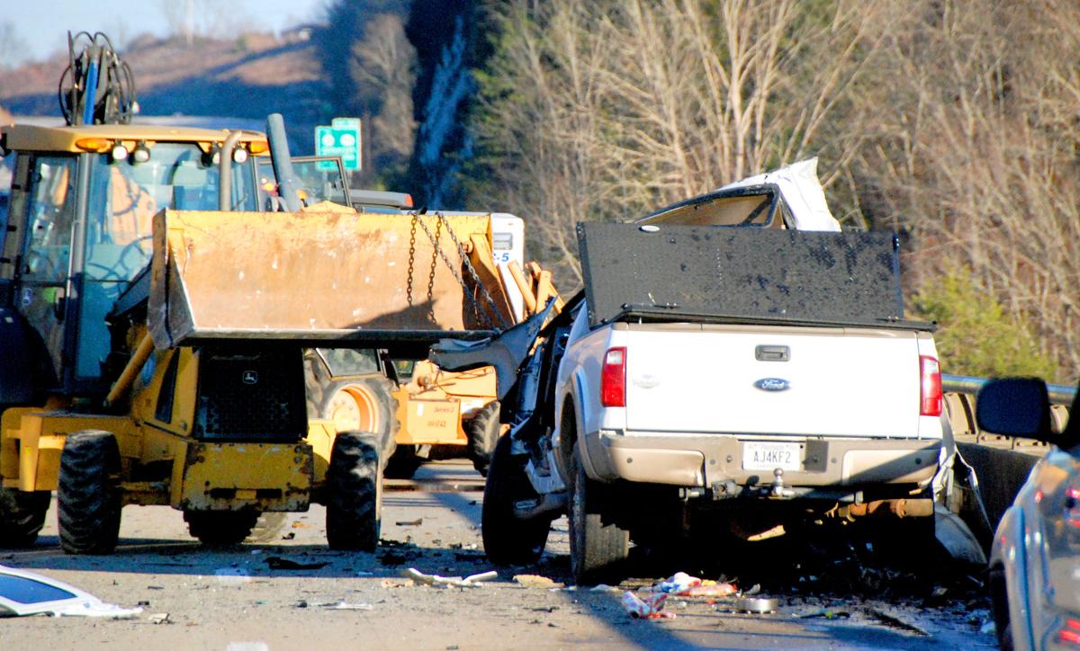 Passenger is killed when truck slams into backhoe on bridge over