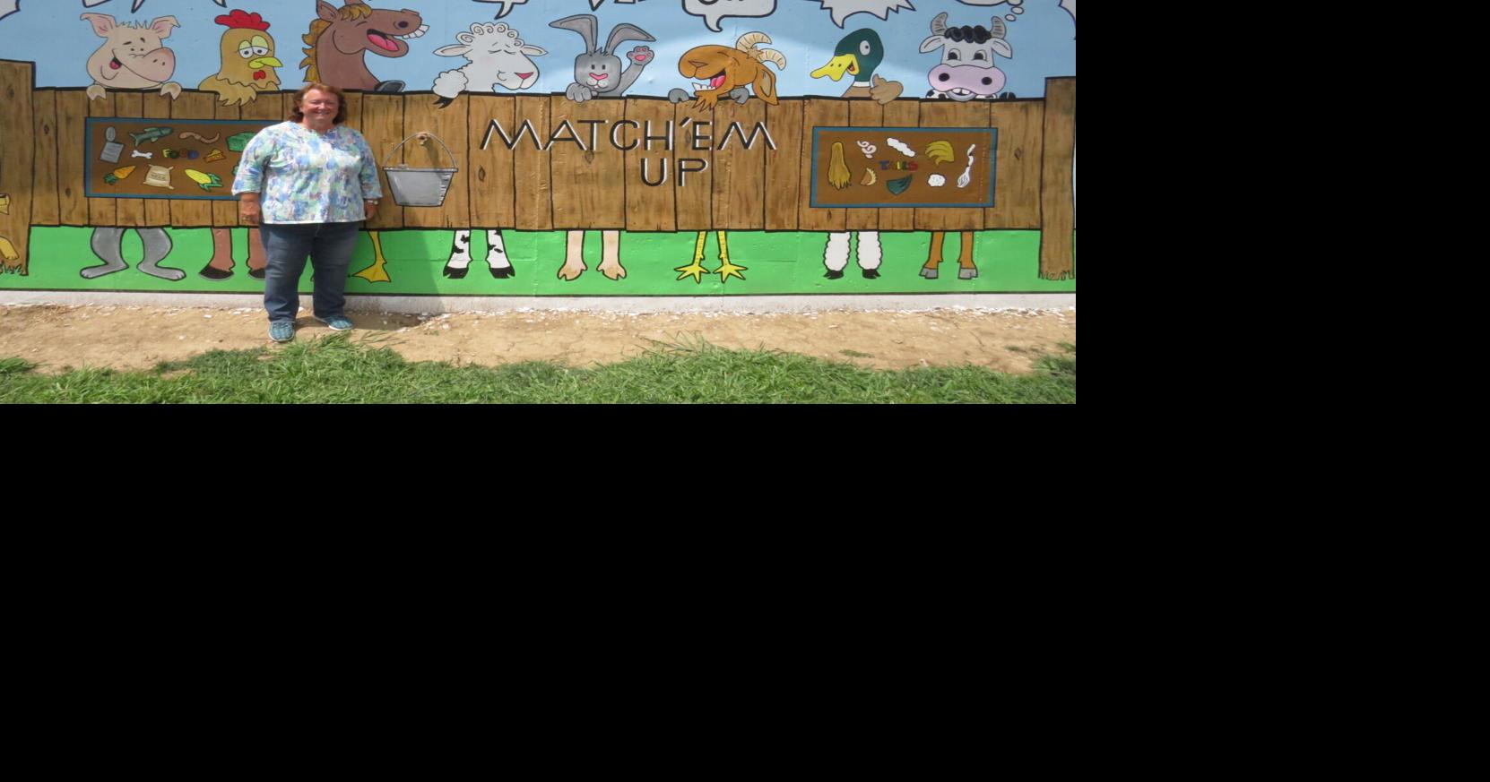 Local artist completes two murals at county fairgrounds