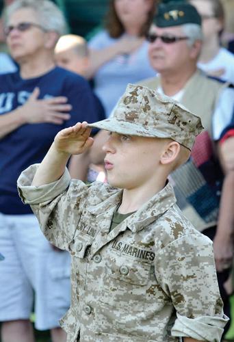 Memorial day. A female soldier in uniform salutes against the