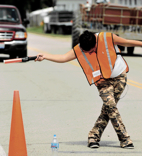 Fair parking attendant provides service with a dance and a curtsy