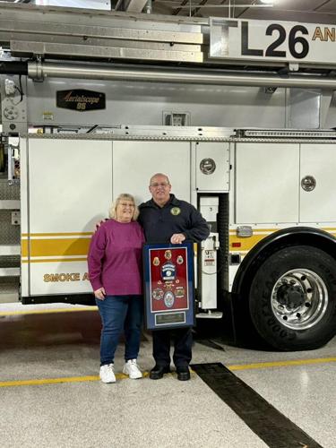 Patricia Holland (left) and Joe Holland at his retirement shadowbox presentation for the Anne Arundel Fire Department.