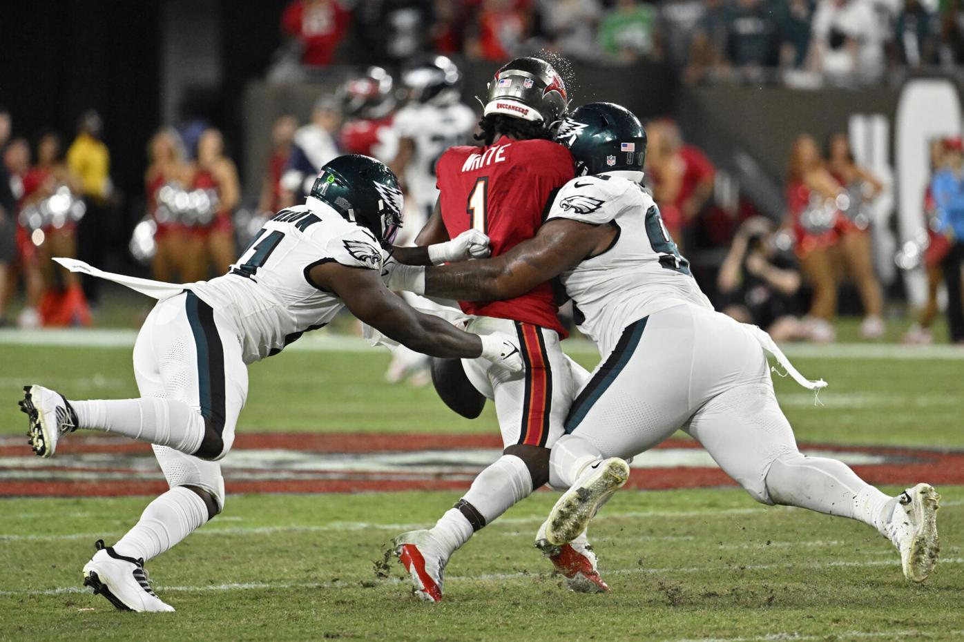 Philadelphia Eagles' Jalen Carter hands his jersey over to a