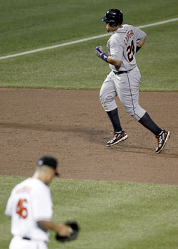 American League's Adam Jones of the Baltimore Orioles hits a sacrifice fly  to score Curtis Granderson of the Detroit Tigers during the eighth inning  of the MLB All-Star baseball game in St.