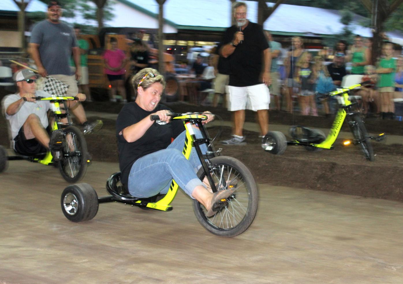 Adults race tricycles at Queen Anne's County Fair Local