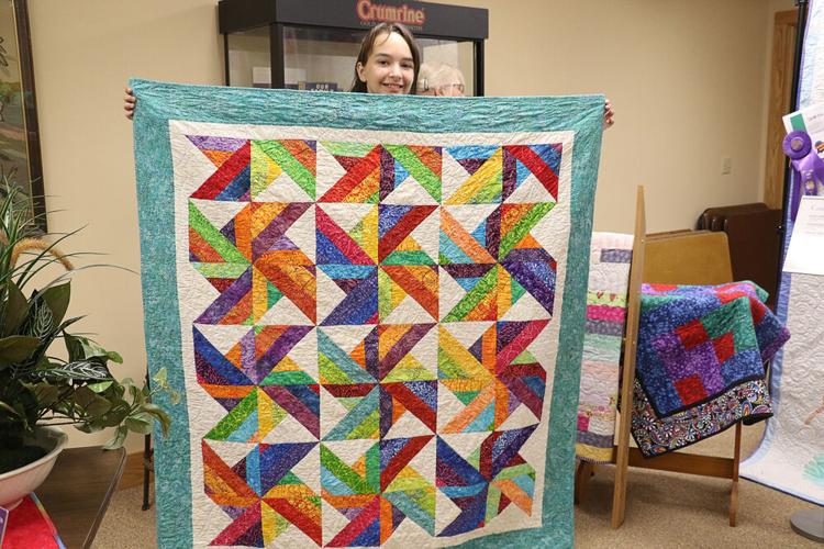 Local and international quilts displayed for an evening of quilt history