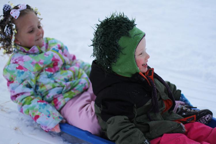 Taking a ride down the sledding hill