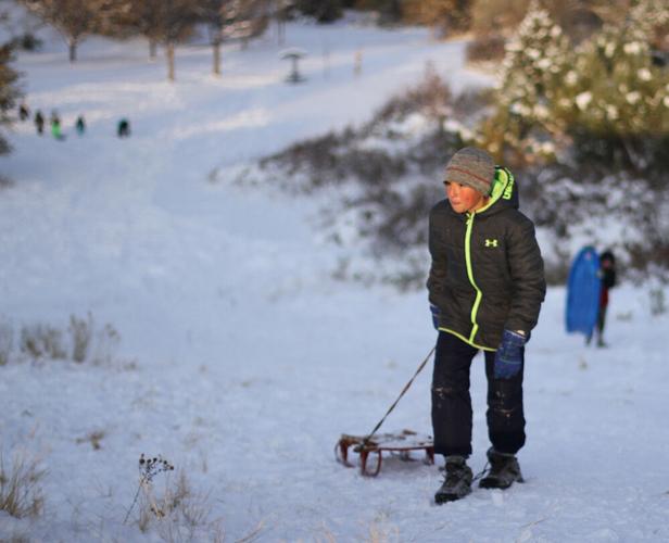 Taking a ride down the sledding hill