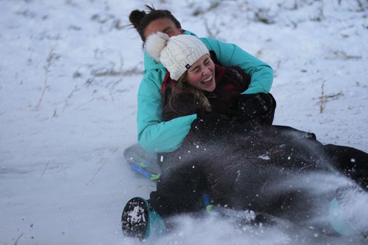 Taking a ride down the sledding hill