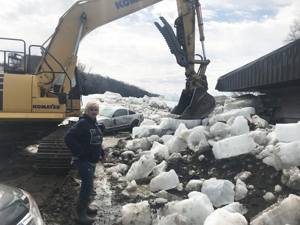Propelled by ferocious floodwaters, huge ice chunks batter buildings in