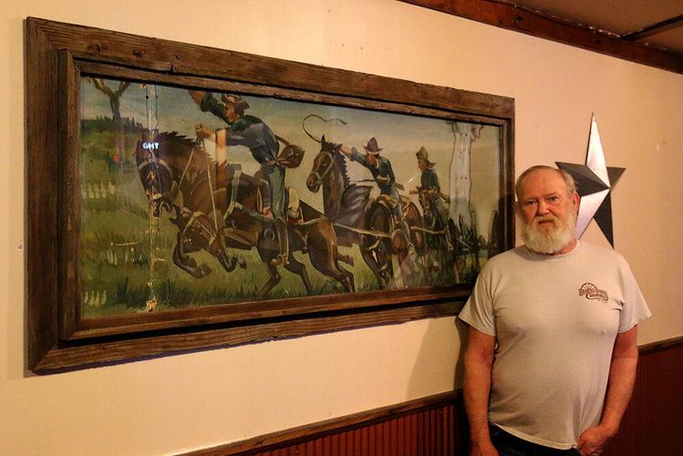 Minatare man discovers art behind restaurant wall
