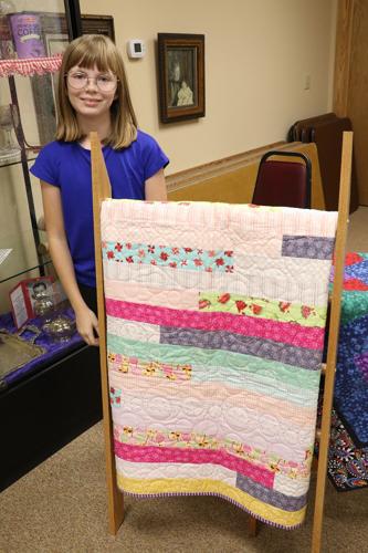 Local and international quilts displayed for an evening of quilt history
