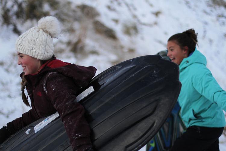 Taking a ride down the sledding hill