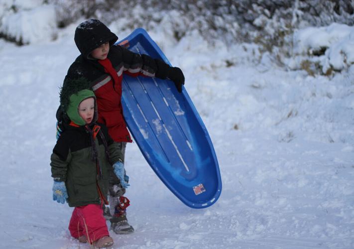 Taking a ride down the sledding hill