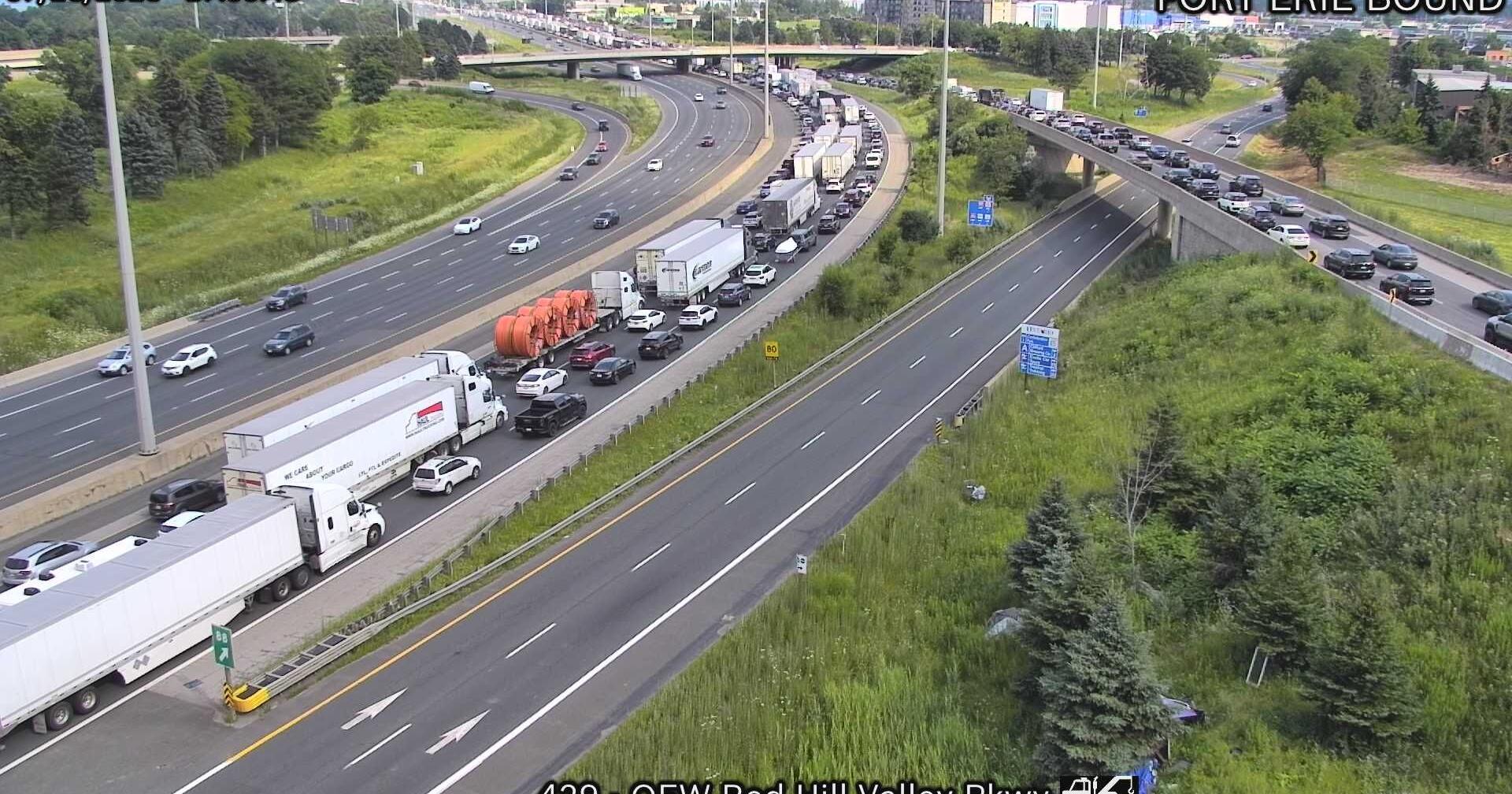 Crash involving police car closes several lanes on QEW