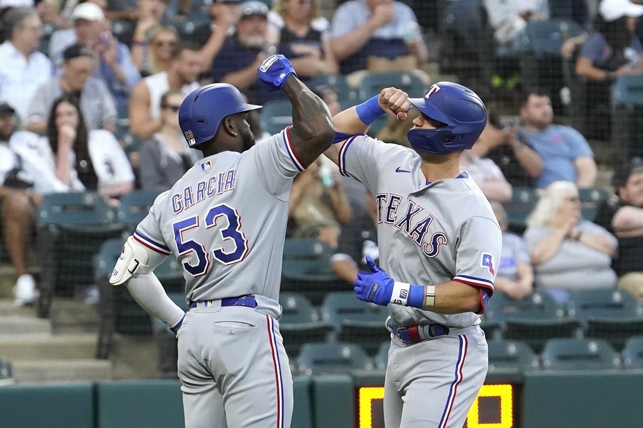 Texas Rangers Josh Hamilton gesters to the dugout after hitting a