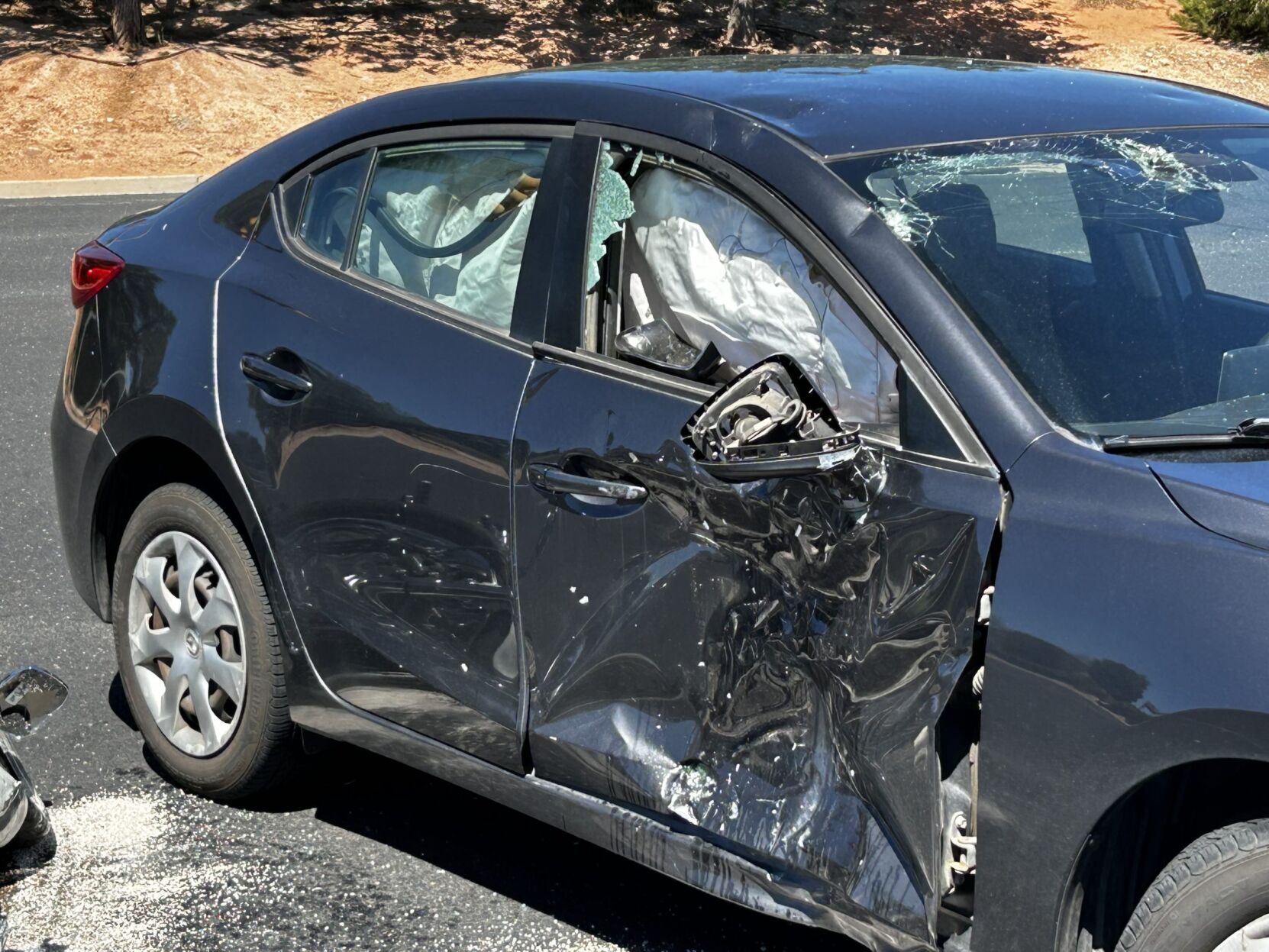 Motorcycle, Mazda collide on Red Cliffs Drive near Megaplex
