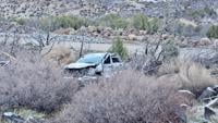 A pickup rests off the side of I-15 after sliding on black ice and rolling early Friday morning near Pintura, Utah, March 14, 2025.