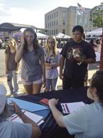 Students pick up backpacks, information during giveaway