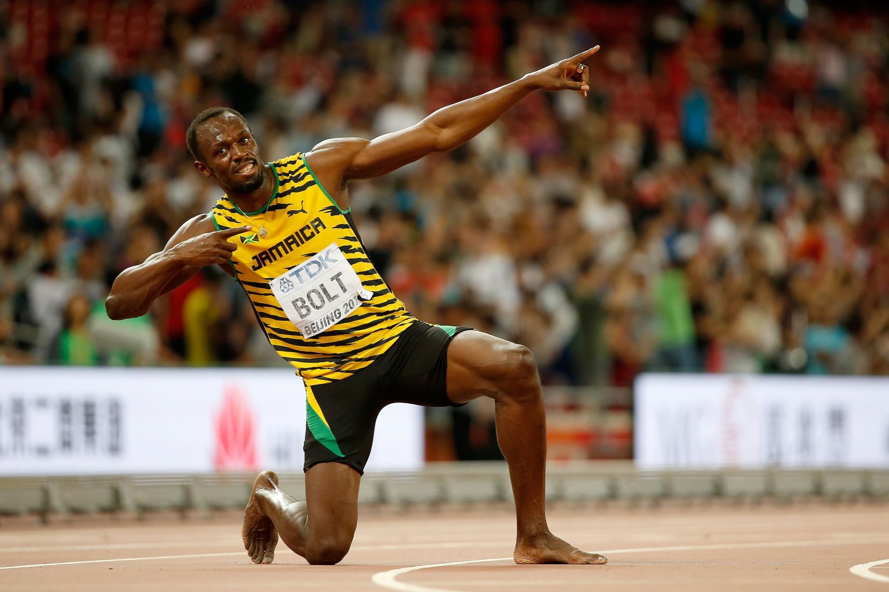 Download Usain Bolt Striking Pose Crowd Watches Wallpaper | Wallpapers.com