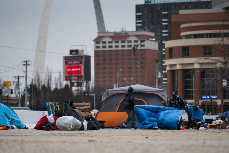 Residents of a homeless encampment in downtown St. Louis pack up their belongings, before the region experienced a deadly cold snap.