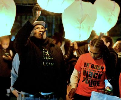 Alvin Miller launches a candle lit balloon in honor of former resident Kevin Johnson 37