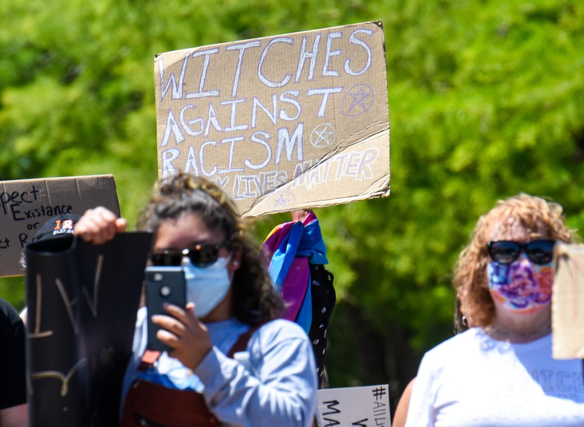 Witches against racism sign