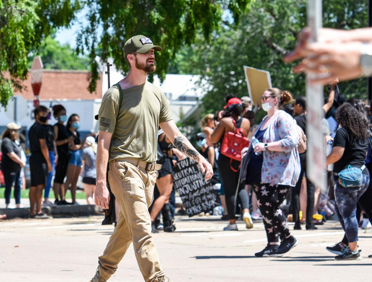 Rifle behind crowd.jpg
